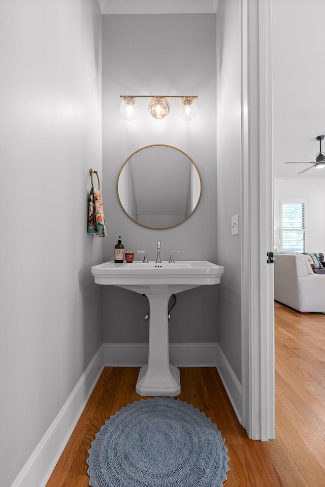 bathroom featuring ceiling fan and hardwood / wood-style flooring