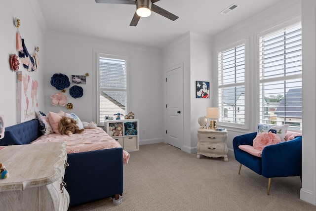 carpeted bedroom with ceiling fan and crown molding