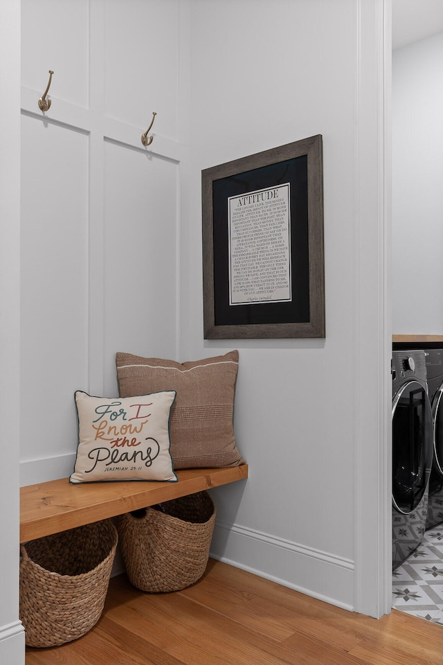 mudroom with washing machine and dryer and light hardwood / wood-style floors