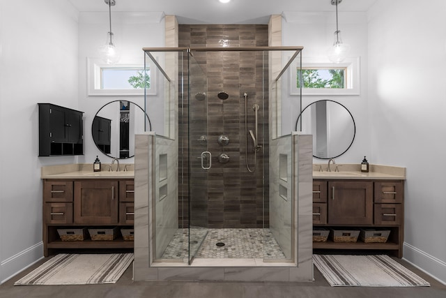 bathroom with walk in shower, vanity, and plenty of natural light