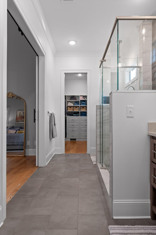 bathroom with vanity, hardwood / wood-style floors, an enclosed shower, and crown molding