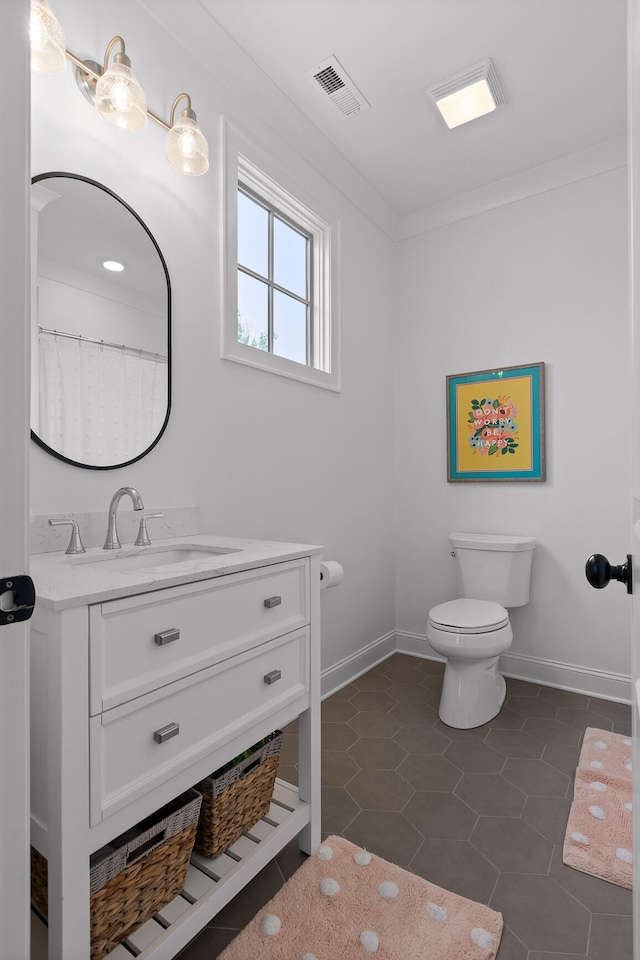 bathroom with curtained shower, tile patterned flooring, vanity, and toilet