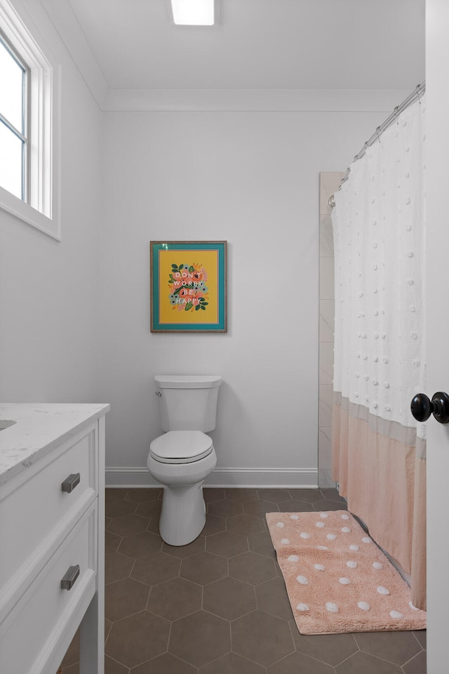 bathroom with curtained shower, vanity, crown molding, toilet, and tile patterned floors