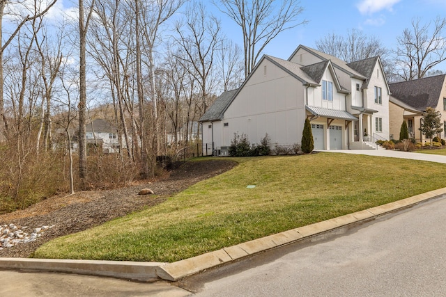 view of side of property featuring a garage and a lawn