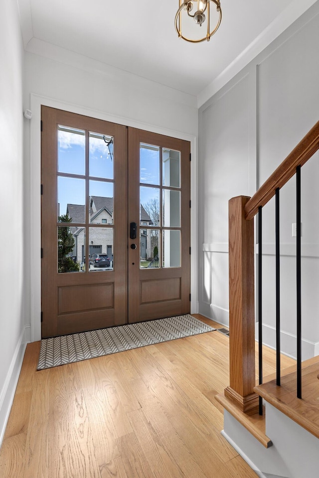 entryway featuring light hardwood / wood-style floors and french doors