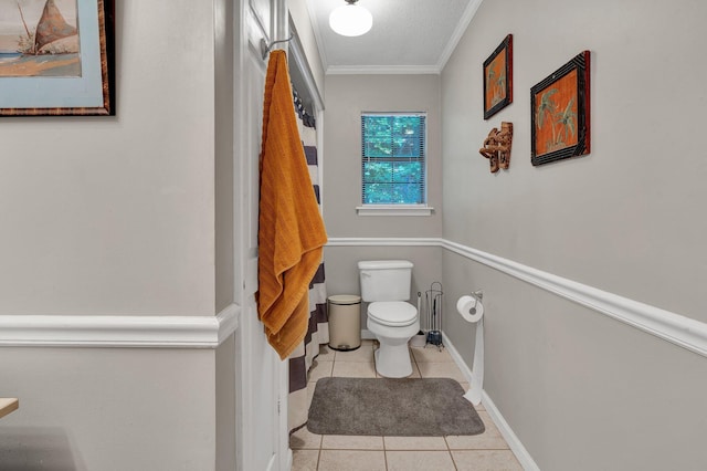 bathroom featuring crown molding, tile patterned flooring, and toilet