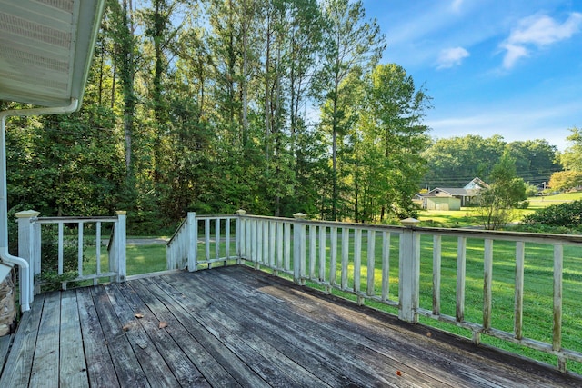 wooden deck featuring a yard