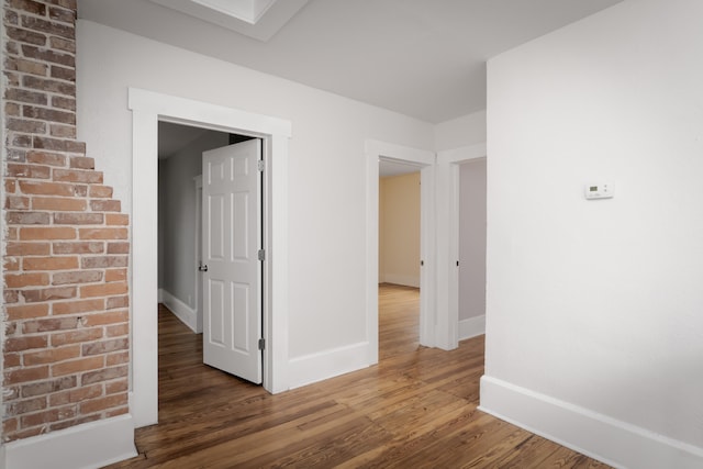 corridor with dark hardwood / wood-style floors