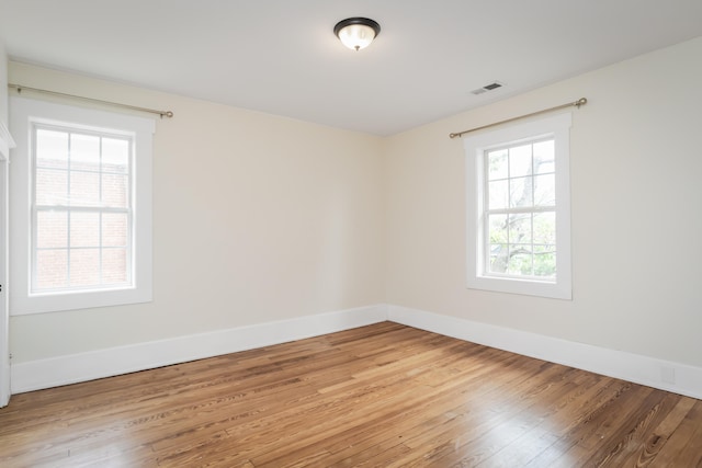 unfurnished room with light wood-type flooring