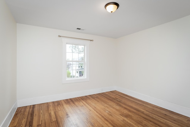 spare room featuring wood-type flooring