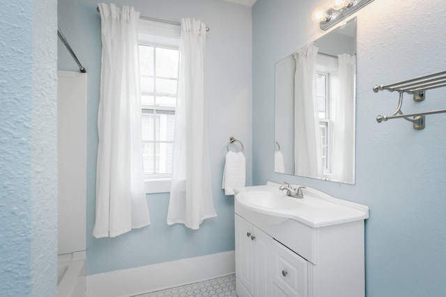 bathroom featuring vanity, tile patterned floors, shower / bath combo, and a wealth of natural light