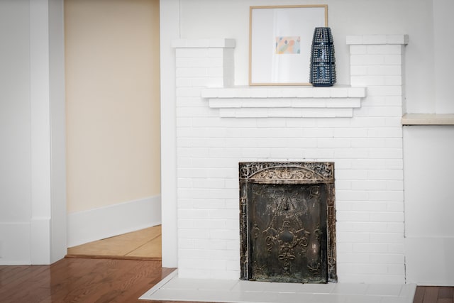 room details with wood-type flooring and a fireplace