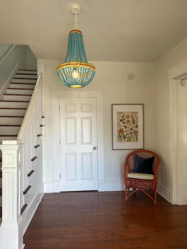 entryway with a notable chandelier and dark hardwood / wood-style floors