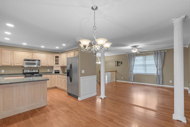 kitchen featuring appliances with stainless steel finishes, hanging light fixtures, ceiling fan with notable chandelier, crown molding, and light hardwood / wood-style flooring