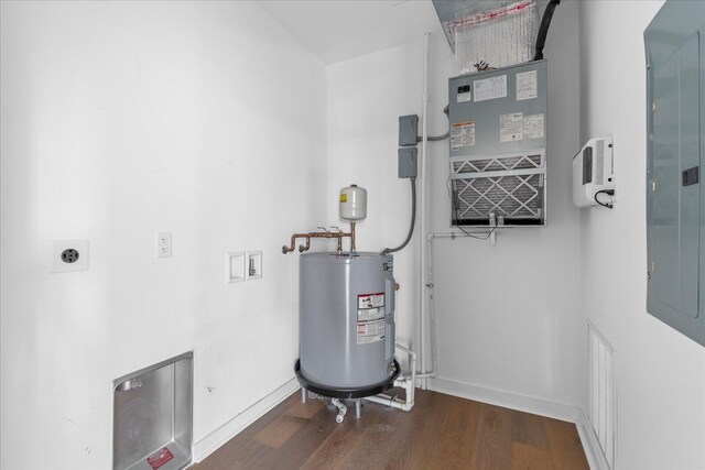 utility room featuring electric water heater and electric panel