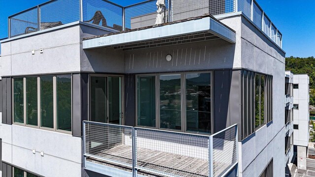 view of side of home with a balcony