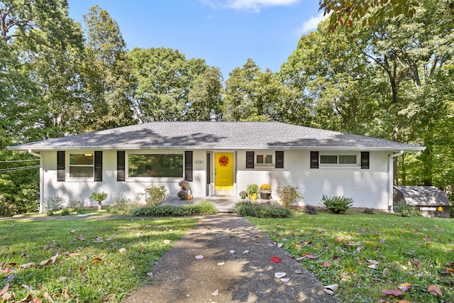 ranch-style home with a front lawn