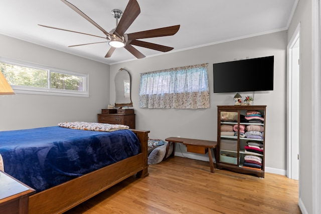 bedroom featuring ceiling fan, light hardwood / wood-style flooring, and ornamental molding