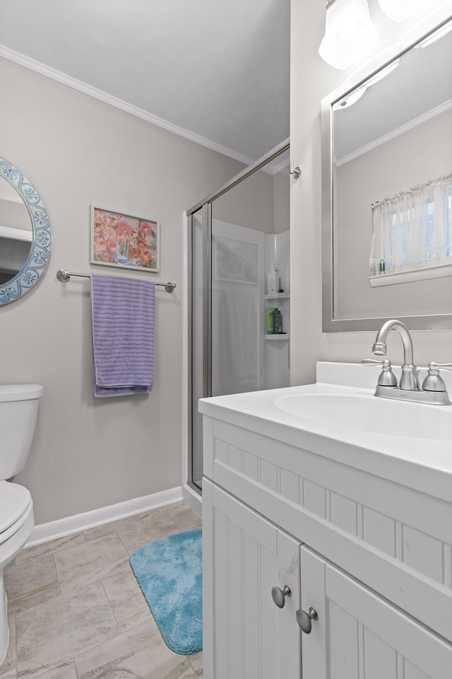 bathroom featuring ornamental molding, vanity, toilet, and a shower with shower door