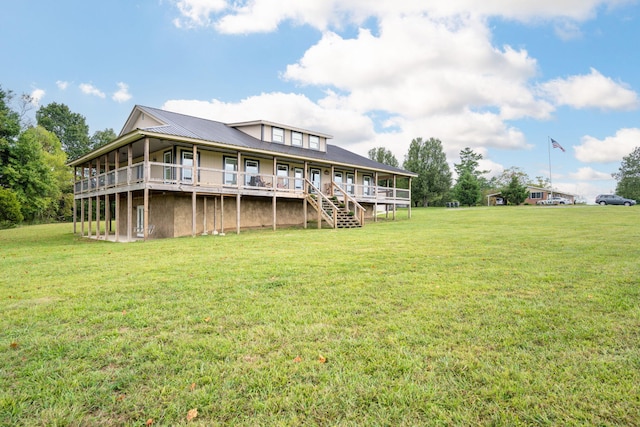 back of property featuring a lawn and a deck