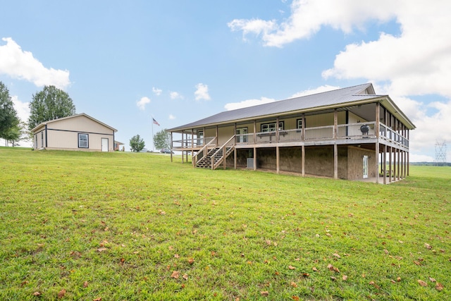 back of property with a wooden deck and a yard