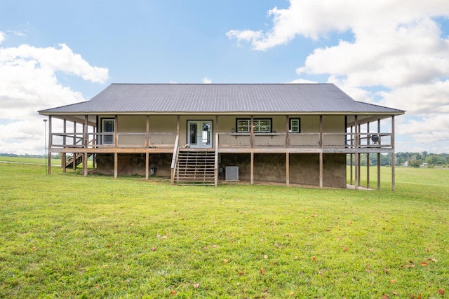 rear view of property with a yard