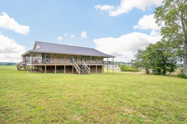 back of property featuring a wooden deck and a lawn