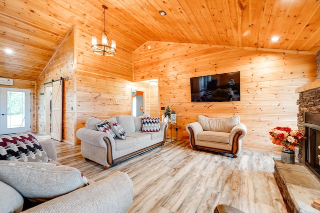 living room with wood walls, hardwood / wood-style floors, and a barn door