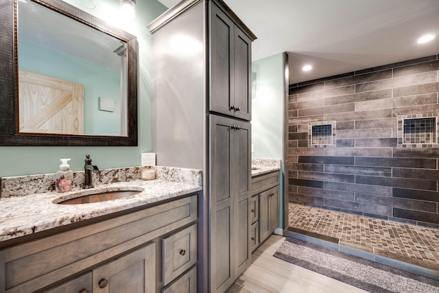 bathroom featuring a shower and vanity