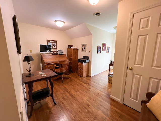 office with wood-type flooring and vaulted ceiling