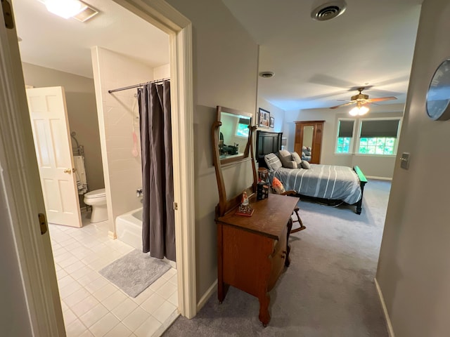 carpeted bedroom featuring ceiling fan, connected bathroom, and a closet