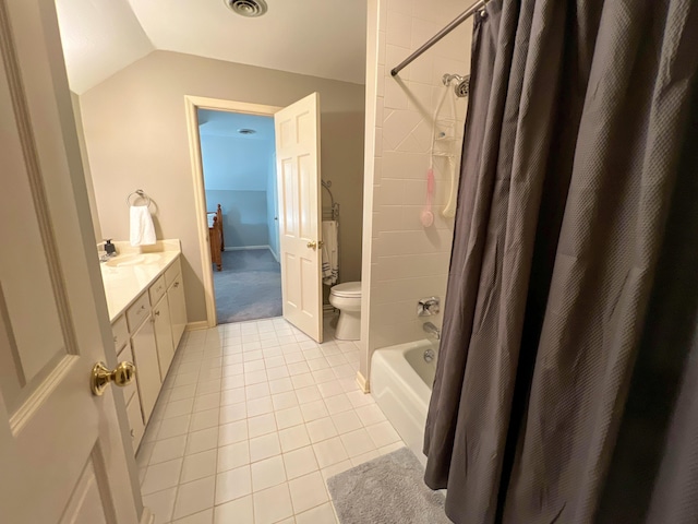 full bathroom featuring tile patterned floors, vaulted ceiling, toilet, shower / bath combo with shower curtain, and vanity