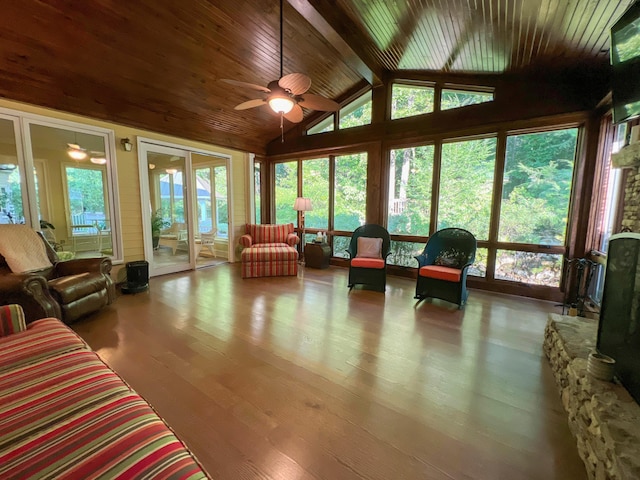 sunroom / solarium featuring vaulted ceiling with beams, ceiling fan, and wood ceiling