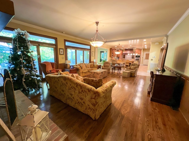 living room featuring wood-type flooring and crown molding