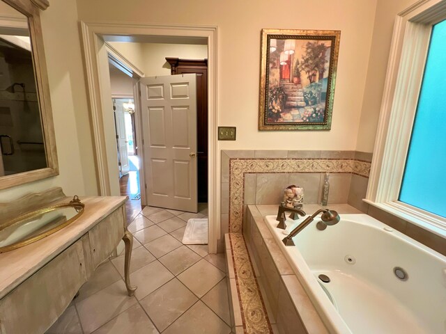 bathroom with tiled bath and tile patterned floors