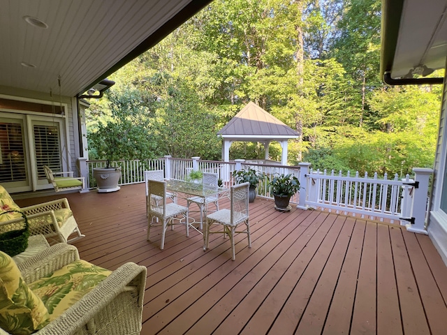 wooden terrace featuring a gazebo