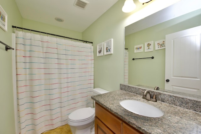 bathroom featuring curtained shower, vanity, and toilet