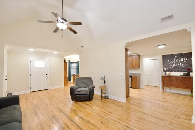 living room featuring crown molding, lofted ceiling, ceiling fan, and light hardwood / wood-style flooring