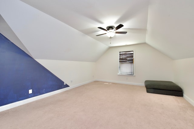 bonus room with vaulted ceiling, ceiling fan, and light colored carpet