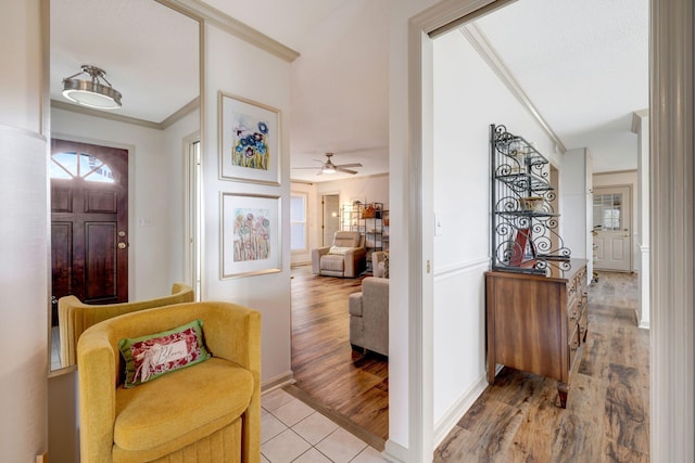 entryway featuring ceiling fan, crown molding, and hardwood / wood-style floors