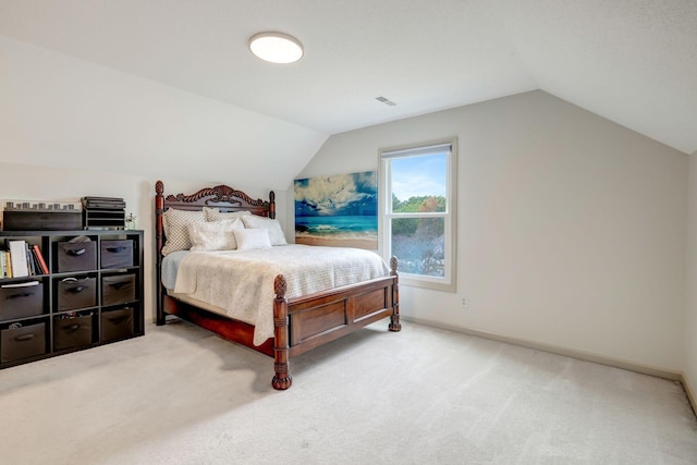 carpeted bedroom with lofted ceiling