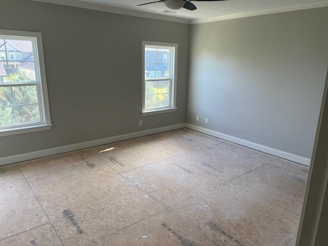 spare room with ceiling fan, plenty of natural light, and crown molding