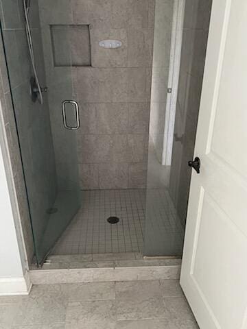 bathroom featuring a shower with shower door