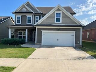 view of front facade featuring a front yard and a garage