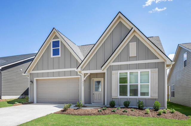 view of front of home with a front lawn and a garage