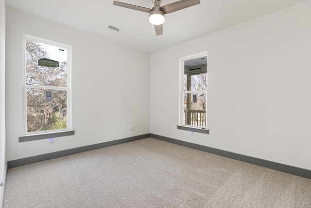 empty room with carpet and ceiling fan