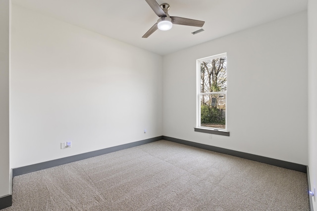 carpeted empty room featuring ceiling fan