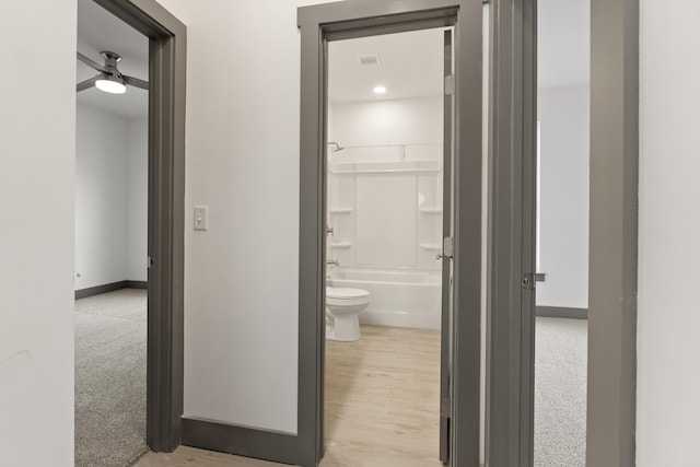 hallway with light hardwood / wood-style floors