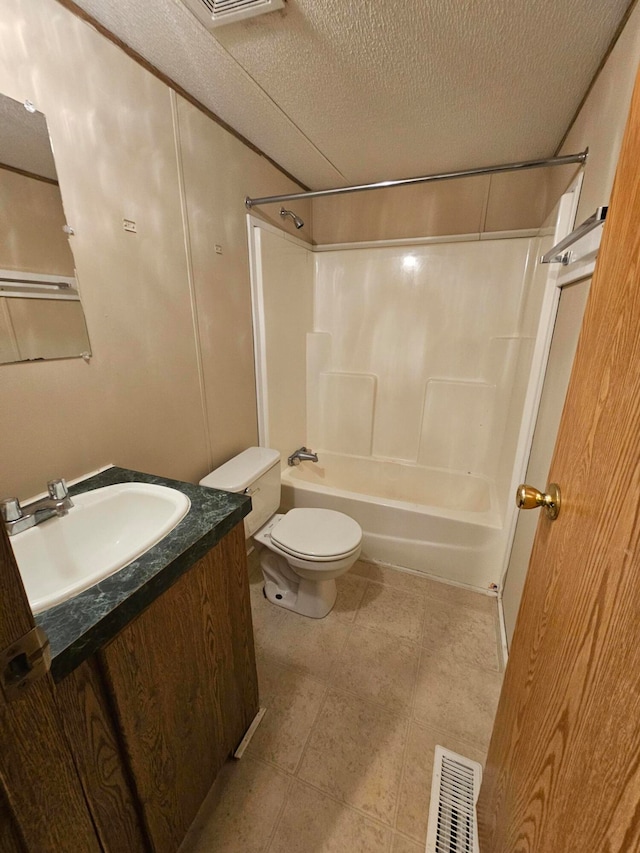 full bathroom featuring vanity, washtub / shower combination, toilet, and a textured ceiling