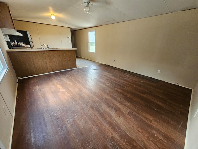 interior space featuring lofted ceiling, ceiling fan, dark hardwood / wood-style floors, and sink